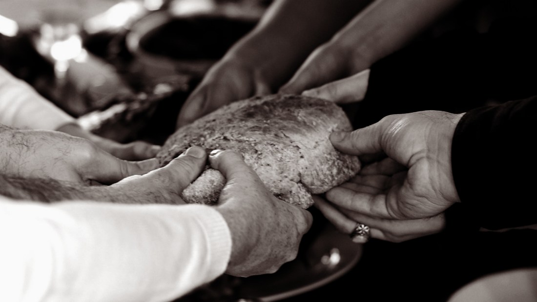 hands breaking bread